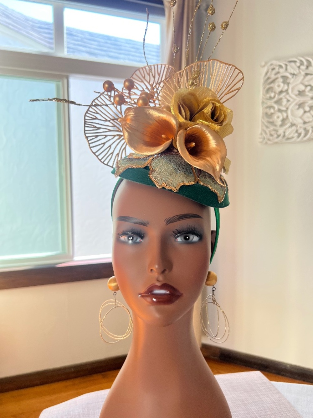 Emerald green base with gold lillies and a floral embroidered appliqué